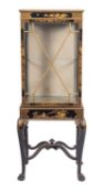 A black lacquered, parcel gilt wood and glazed display cabinet on stand, in George I taste,