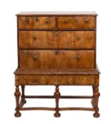 A George I walnut chest on stand, circa 1725 and later; the top with moulded edges,