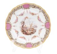 A Meissen porcelain plate painted with a busy harbour scene vignette within pendant garlands and