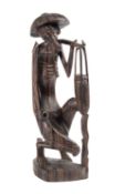 A South East Asian carved hardwood figure of a farmer, 30cm.