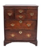 An oak chest of drawers, early 18th century; the top with moulded edges,