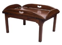 A mahogany butler's tray on stand in George III style, 20th century; of bowed rectangular form,
