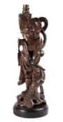 A Chinese carved hardwood wood figure leading a mythical beast,