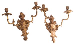 A pair of Continental carved and giltwood and gilt metal mounted twin-light wall appliques,