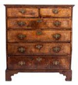 A substantial George II walnut and crossbanded chest of drawers,
