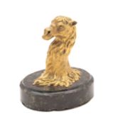 A gilt bronze and polished serpentine mounted desk weight cast as the head of a camel,
