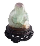 A Chinese carved fluorite figure of Budai, 6.5cm on carved wood stand.