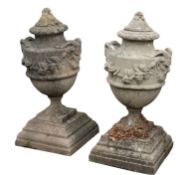 A set of four stone composition garden urns,
