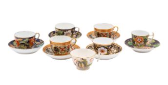 A group of six early 19th century Coalport and other cups and saucers and a single cup decorated in