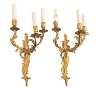 A pair of gilt metal three-light wall appliques in Louis XV style,
