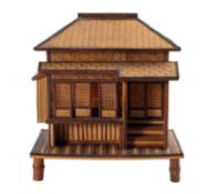A Japanese woven bamboo model of a Minka [traditional tea house] with sliding doors set on a