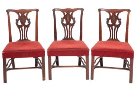 A set of three George III mahogany dining chairs,