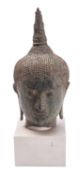 A Thai bronze head of Buddha with curled hair, serene expression,