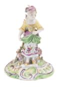An early Derby [Pale Family] figure of the Farmer's Wife, circa 1756-58 wearing puce hat,