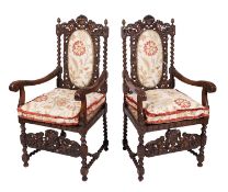 A pair of carved beechwood open armchairs in the Charles II taste,