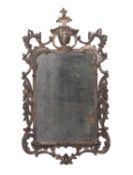 A carved and silvered wood framed rectangular wall mirror in George III style,