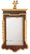 A walnut and parcel gilt wall mirror in George II style,