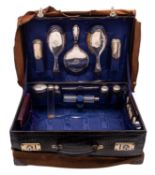 An early 20th century black crocodile leather dressing case,