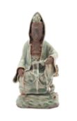 A Chinese Longquan celadon-glazed and biscuit figure of Guanyin, Qing dynasty in Ming style,