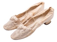 A pair of Victorian lady's ivory silk slippers (shoes),