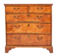 A George III elm chest of drawers,