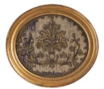 An Indian gilt-metal thread embroidered oval panel,