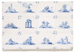 A panel of twelve Dutch Delft tiles painted in blue with biblical scenes within spider corners