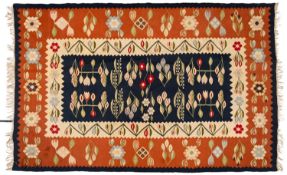 An Anatolian kelim, the indigo field with a design of flowering stems,