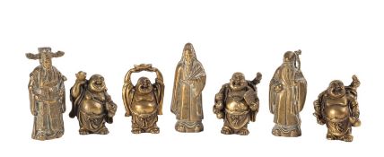A set of four small bronze figures of Budai and three similar figures of Immortals, 9cm [7].