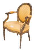A carved and giltwood elbow chair in George III style,