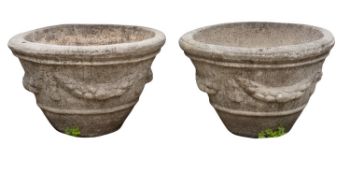 A pair of stone composition garden planters,