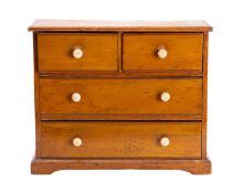A deal and pine miniature chest of drawers,