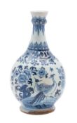 A Dutch Delft bottle vase with garlic shaped neck painted in blue with paired pheasants amongst