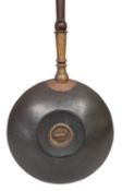 A Victorian copper and brass bed warming pan, last quarter 19th century; of circular, cushion form,