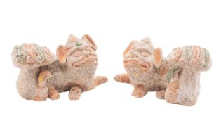 A pair of Chinese terracotta Fu dogs in Tang style with polychrome decoration,