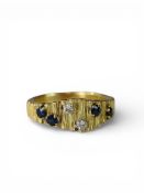 An 18 carat Gold Textured Ring, set with Four Sapphires and Two Diamonds, marked 18 carat, date mark