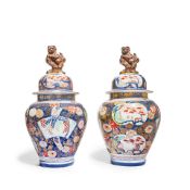 A pair of Japanese Imari decorated porcelain garniture vases and covers Late Meiji period (1868-...