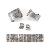 A group of Jared Chavez silver jewelry, including two cuff bracelets, a link bracelet and matchi...