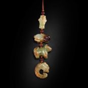 A STRING OF FOUR JADE ORNAMENTS Zhou Dynasty and later (4)