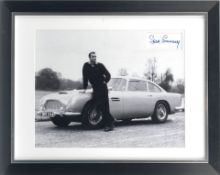 A framed Sean Connery James Bond image featuring the 'Goldfinger' Aston Martin DB5, with signature,