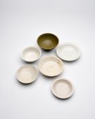 FIVE WHITE-GLAZED BOWLS, AND A LONGQUAN CELADON BOWL Three of Cizhou type, probably Ming Dynasty...