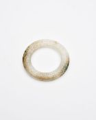 A WHITE JADE 'CLOUD' RING WITH RUSSET AND GREEN INCLUSIONS Han Dynasty style