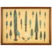 TWO DISPLAY CASES WITH BRONZE DAGGERS AND ARROW POINTS.