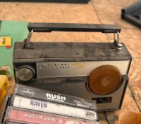 Vintage GE am/fm radio with box of cassette tapes