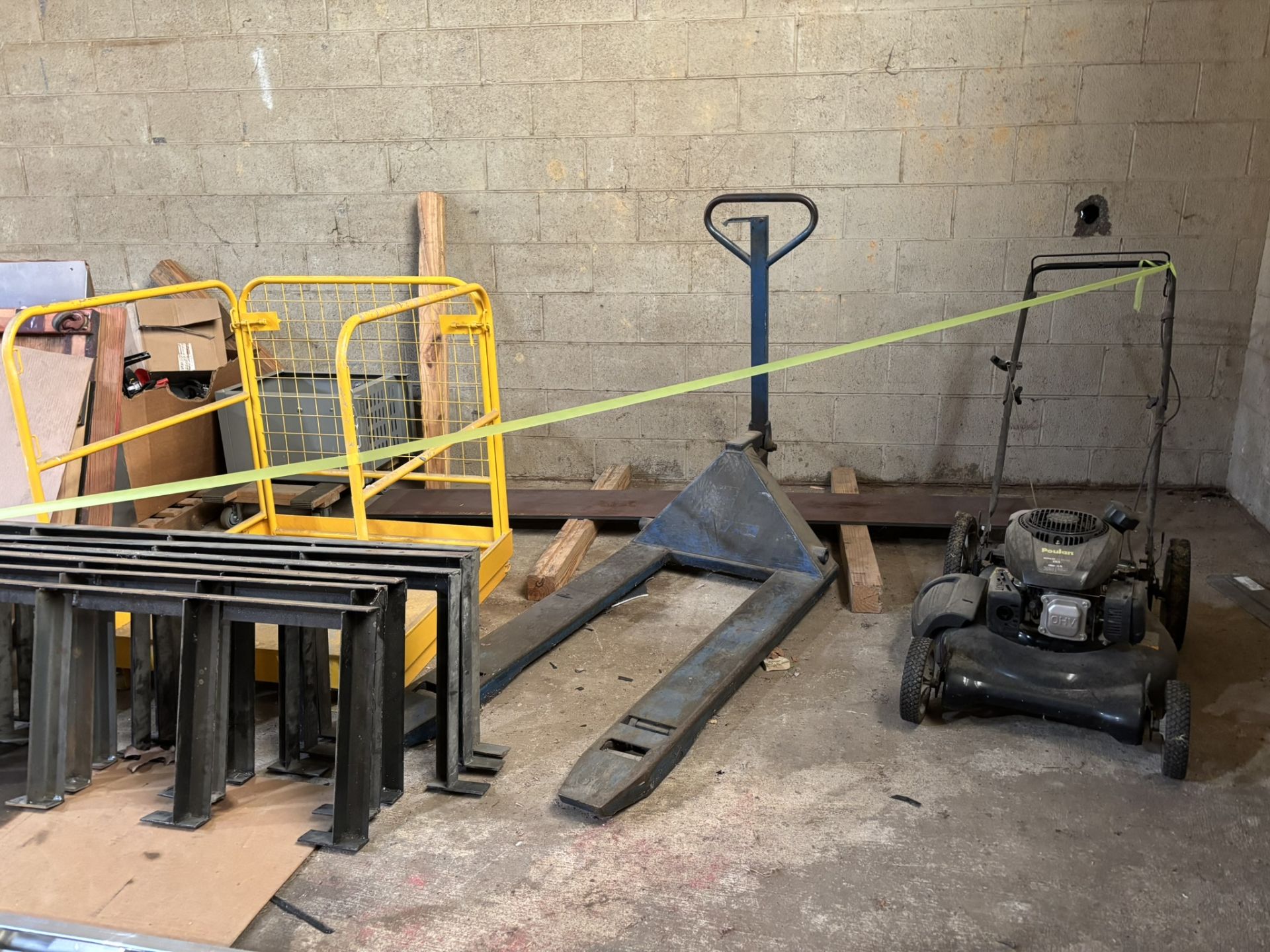 Everything Behind Yellow Ribbon - Pallet Jack, Poulin Push Lawn Mower, Extension Cord Reels, Paint