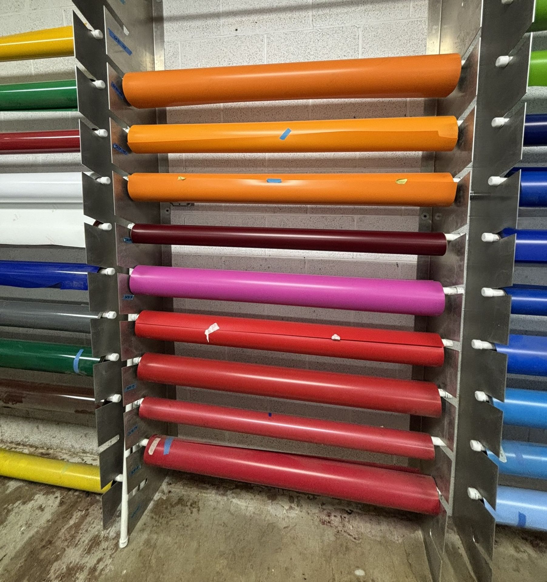 Approximately 9 Partial Rolls of 4' Vinyl, Assorted Colors, Plus Rolled Vinyl Storage Rack