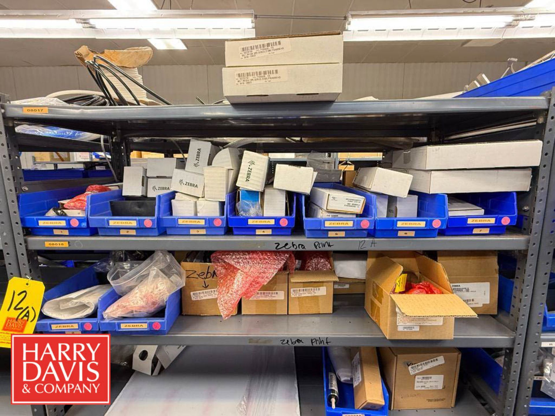 Zebra Printer Rack Rack with Assorted Zebra Printer Parts, Including: Media Kits, Drive ...