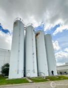 LOT OF (8) SILOS, 55'H + HANDRAIL X 12'DIA, 5.66' CORE HEIGHT, 1.00' OUTLET WDTH, EACH SILO HOLDS