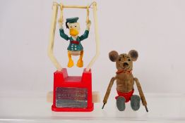Schuco - A 1930s Schuco clockwork mouse. Brown velvet with red shorts. Approximately 9.5 cm tall.