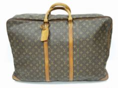 A Louis Vuitton Brown Monogram Keepall Travel Bag. Brown monogram coated canvas exterior with gold-